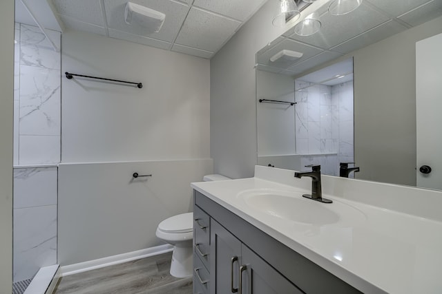 4207 Fillmore St NE, Columbia Heights, MN 55421 - bathroom featuring a paneled ceiling, vanity, toilet, wood finished floors, and a shower