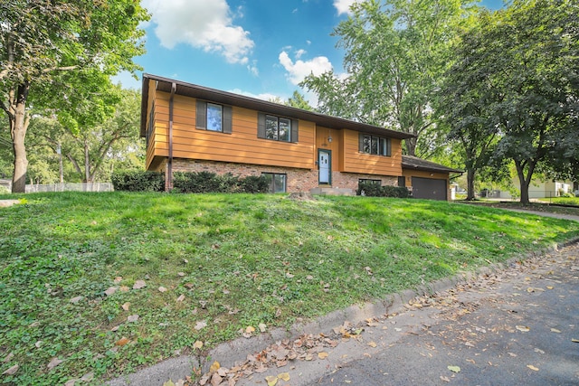 4207 Fillmore St NE, Columbia Heights, MN 55421 - raised ranch featuring a garage, brick siding, and a front lawn