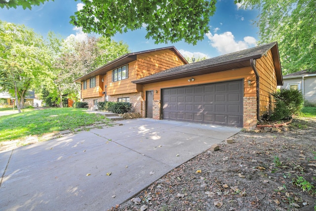 4207 Fillmore St NE, Columbia Heights, MN 55421 - view of front of property with brick siding, concrete driveway, an attached garage, and a front yard