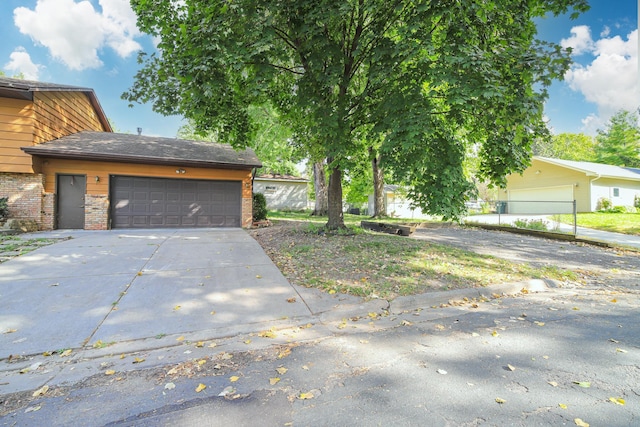 4207 Fillmore St NE, Columbia Heights, MN 55421 - view of front of home featuring brick siding, concrete driveway, and an attached garage