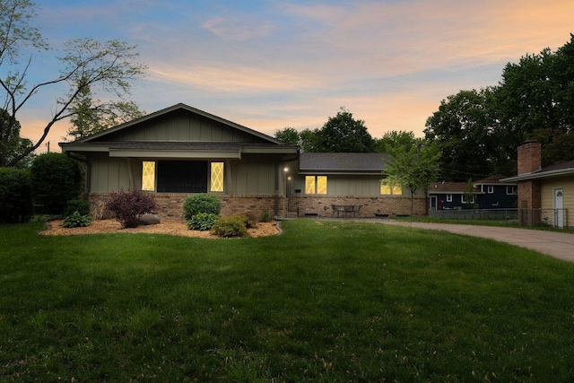 4017 Kentucky Ave N, Crystal, MN 55427 - view of front facade featuring board and batten siding, a front lawn, and brick siding
