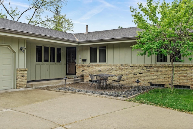 4017 Kentucky Ave N, Crystal, MN 55427 - entrance to property with board and batten siding, brick siding, roof with shingles, and concrete driveway