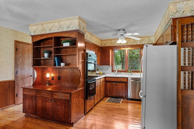 4017 Kentucky Ave N, Crystal, MN 55427 - kitchen featuring freestanding refrigerator, stainless steel dishwasher, a textured ceiling, ceiling fan, and light wood-style floors