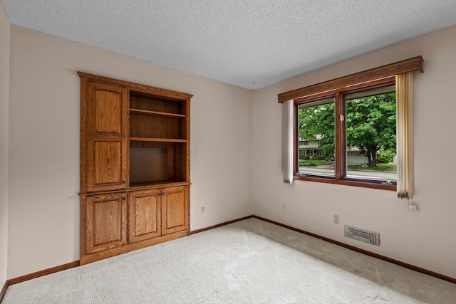 4017 Kentucky Ave N, Crystal, MN 55427 - spare room featuring light carpet, baseboards, and a textured ceiling