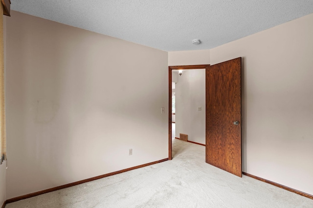 4017 Kentucky Ave N, Crystal, MN 55427 - spare room featuring light carpet, a textured ceiling, baseboards, and a smoke detector