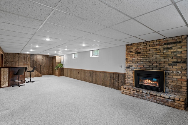 4017 Kentucky Ave N, Crystal, MN 55427 - below grade area with wooden walls, carpet floors, a brick fireplace, a dry bar, and a paneled ceiling