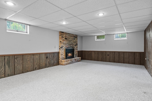 4017 Kentucky Ave N, Crystal, MN 55427 - basement with wainscoting, wood walls, a brick fireplace, carpet flooring, and a paneled ceiling