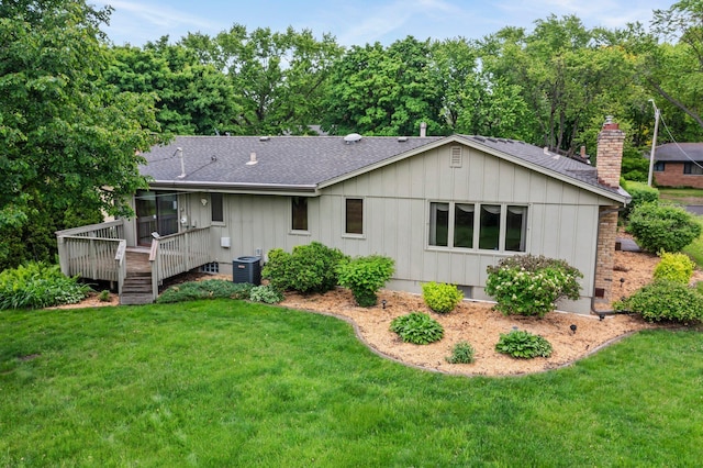 4017 Kentucky Ave N, Crystal, MN 55427 - back of property with board and batten siding, cooling unit, roof with shingles, and a deck