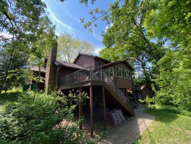 7481 Mariner Dr, Maple Grove, MN 55311 - rear view of house featuring stairway, a deck, and a chimney