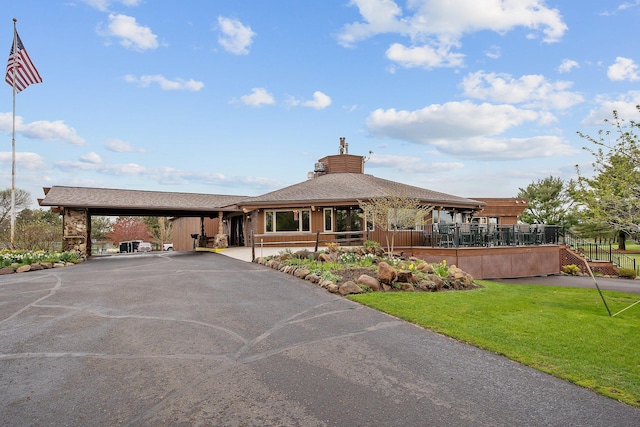 view of building exterior with driveway and a carport