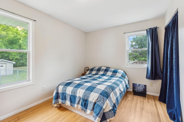 1224 N St NE, Brainerd, MN 56401 - bedroom with baseboards and wood finished floors