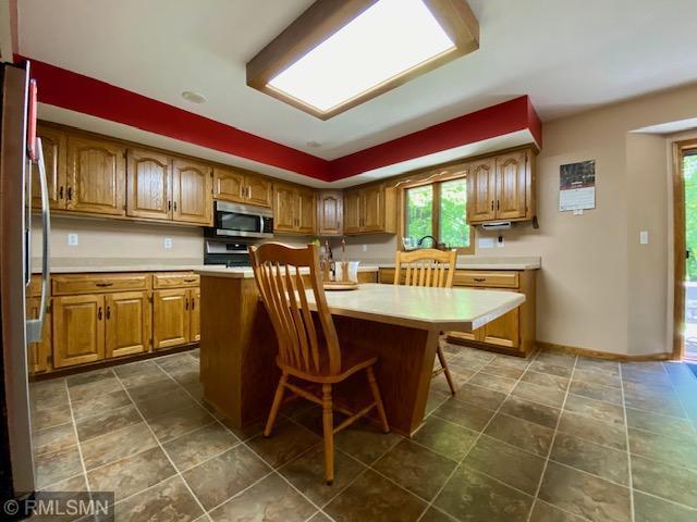 23110 Grandview Loop, Long Prairie Twp, MN 56347 - kitchen with appliances with stainless steel finishes, healthy amount of natural light, light countertops, and a kitchen breakfast bar