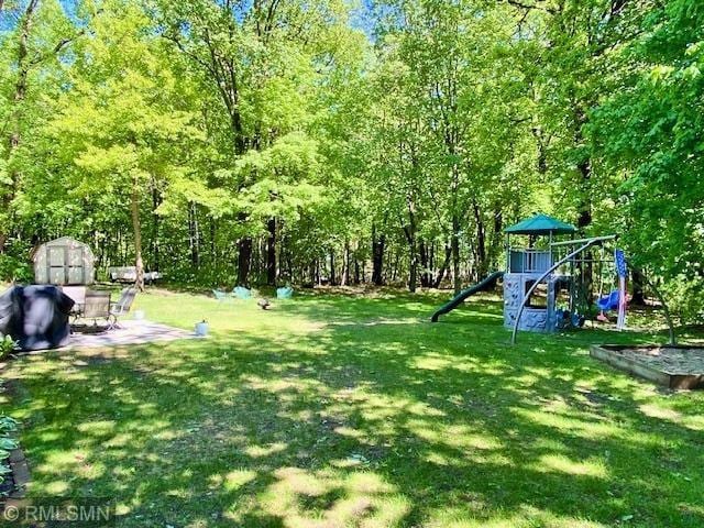 23110 Grandview Loop, Long Prairie Twp, MN 56347 - view of green lawn featuring a playground and a view of trees