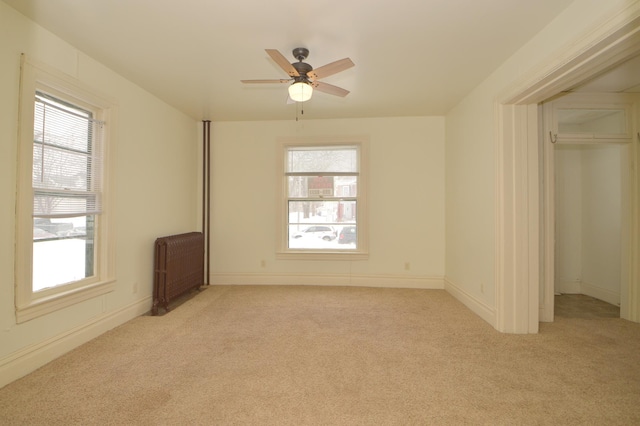 508 6th Ave S, Saint Cloud, MN 56301 - unfurnished bedroom with radiator, multiple windows, and light carpet