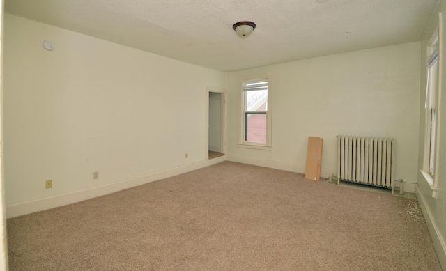 508 6th Ave S, Saint Cloud, MN 56301 - unfurnished room featuring radiator, carpet floors, and baseboards