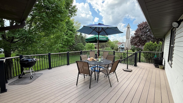 656 Mina Ct, Mahtomedi, MN 55082 - wooden deck with outdoor dining area, a grill, and a lawn