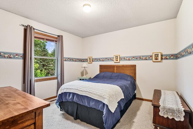 656 Mina Ct, Mahtomedi, MN 55082 - carpeted bedroom featuring baseboards and a textured ceiling