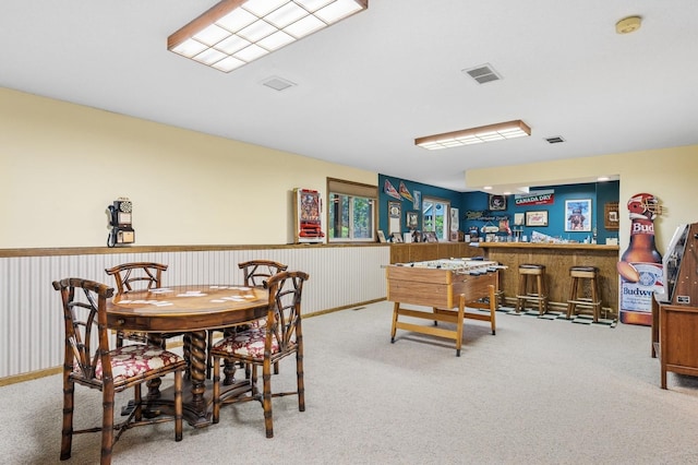 656 Mina Ct, Mahtomedi, MN 55082 - dining room featuring carpet, a bar, and wainscoting