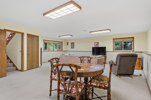 656 Mina Ct, Mahtomedi, MN 55082 - dining area featuring stairway, light carpet, and a wainscoted wall