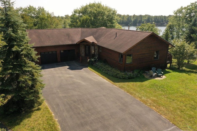 1729 Quail Ln NE, Longville, MN 56655 - log cabin featuring driveway, an attached garage, a water view, a front yard, and a forest view