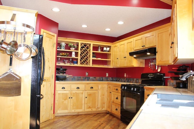 1729 Quail Ln NE, Longville, MN 56655 - kitchen featuring black appliances, under cabinet range hood, open shelves, light wood-style flooring, and light brown cabinets