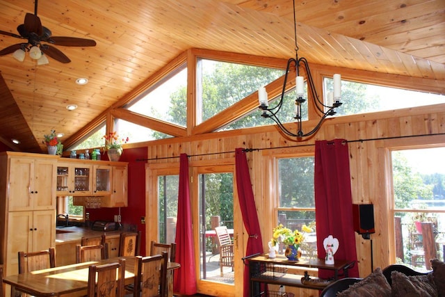 1729 Quail Ln NE, Longville, MN 56655 - dining room with wooden ceiling, a chandelier, lofted ceiling, wood walls, and a ceiling fan
