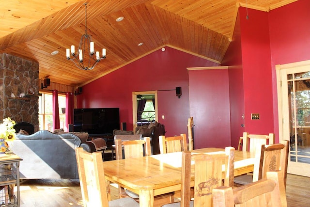 1729 Quail Ln NE, Longville, MN 56655 - dining space with wood finished floors, a chandelier, vaulted ceiling, wooden ceiling, and a stone fireplace