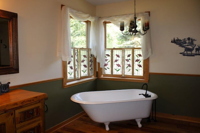 1729 Quail Ln NE, Longville, MN 56655 - full bathroom featuring a freestanding tub, a chandelier, wood finished floors, and vanity
