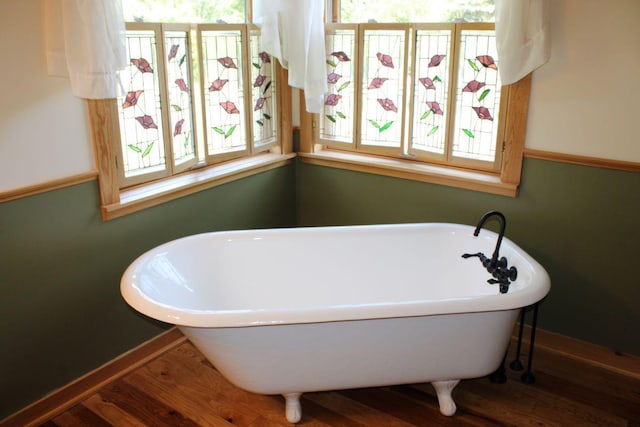 1729 Quail Ln NE, Longville, MN 56655 - bathroom with plenty of natural light, wood finished floors, a freestanding tub, and baseboards