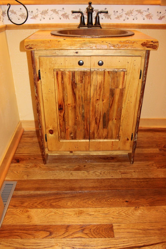1729 Quail Ln NE, Longville, MN 56655 - detailed view of a sink, wood finished floors, and baseboards