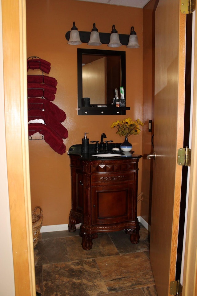 1729 Quail Ln NE, Longville, MN 56655 - bathroom with vanity, baseboards, and stone finish floors