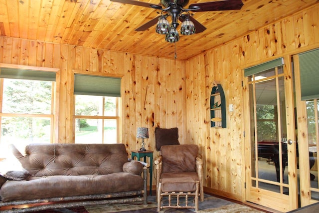1729 Quail Ln NE, Longville, MN 56655 - living area featuring healthy amount of natural light, wood ceiling, wood walls, and ceiling fan