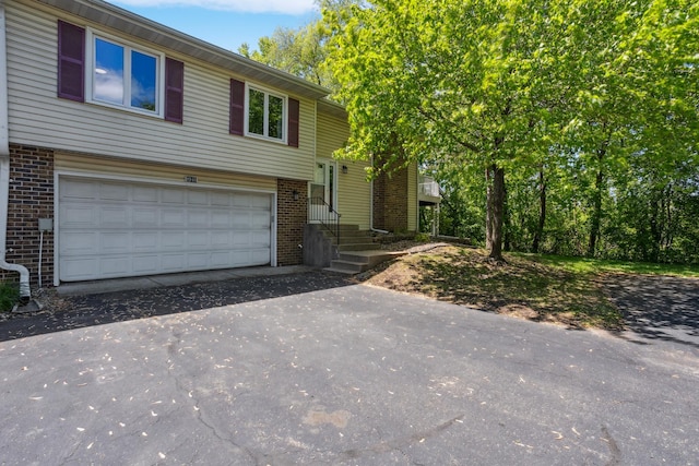 9940 Cavell Ave S, Bloomington, MN 55438 - bi-level home featuring brick siding, driveway, and an attached garage