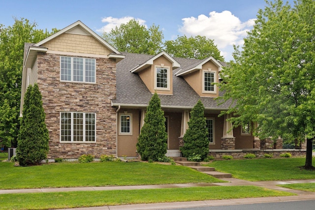 9885 Troy Ln N, Maple Grove, MN 55311 - view of front facade with stone siding, roof with shingles, a front lawn, and stucco siding