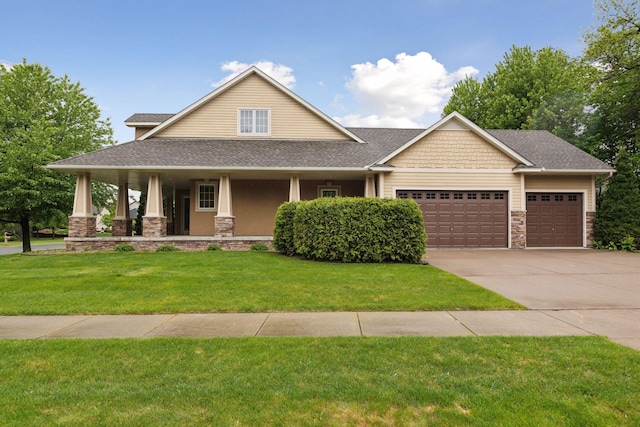 9885 Troy Ln N, Maple Grove, MN 55311 - craftsman-style house with an attached garage, driveway, stone siding, roof with shingles, and a front lawn