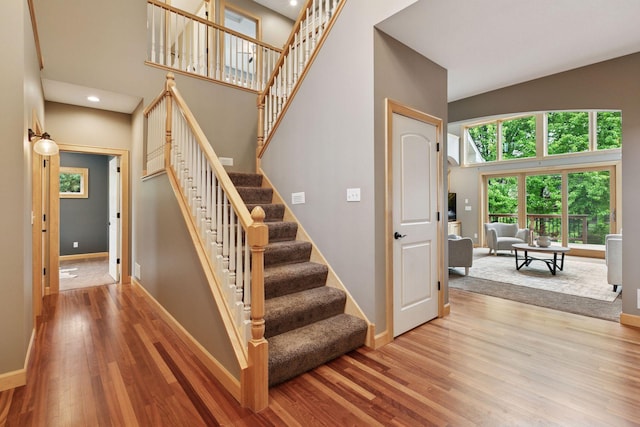 9885 Troy Ln N, Maple Grove, MN 55311 - stairs with a towering ceiling, baseboards, wood finished floors, and recessed lighting