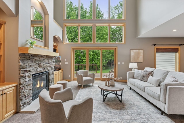 9885 Troy Ln N, Maple Grove, MN 55311 - living room with a high ceiling, a fireplace, baseboards, and arched walkways
