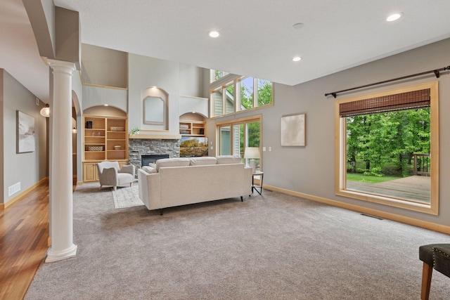 9885 Troy Ln N, Maple Grove, MN 55311 - carpeted living area featuring baseboards, ornate columns, a fireplace, recessed lighting, and built in shelves