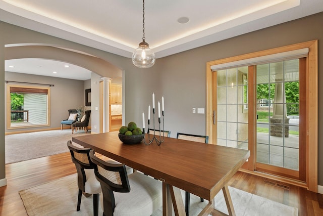 9885 Troy Ln N, Maple Grove, MN 55311 - dining space with arched walkways, decorative columns, plenty of natural light, wood finished floors, and recessed lighting