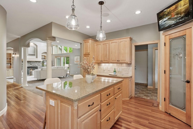 9885 Troy Ln N, Maple Grove, MN 55311 - kitchen with light brown cabinets, decorative columns, light wood-type flooring, backsplash, and recessed lighting