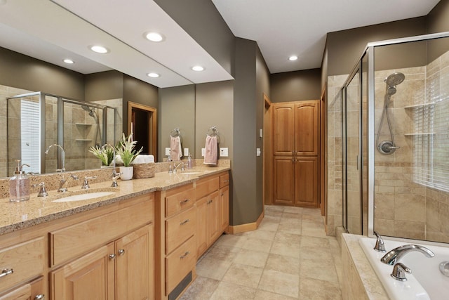 9885 Troy Ln N, Maple Grove, MN 55311 - bathroom featuring a shower stall, double vanity, a garden tub, recessed lighting, and baseboards