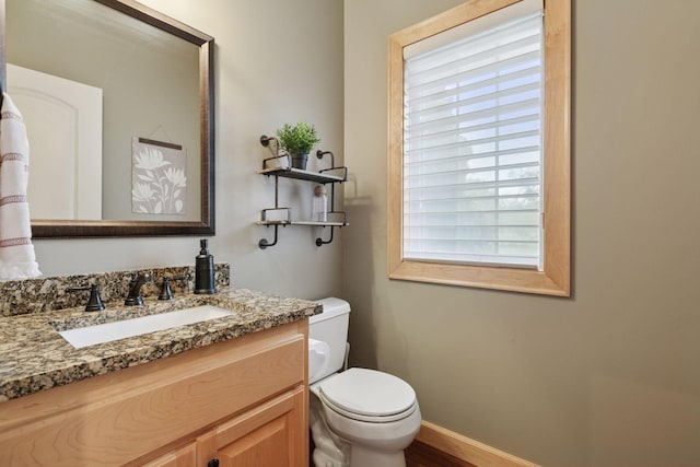 9885 Troy Ln N, Maple Grove, MN 55311 - bathroom with vanity, toilet, and baseboards