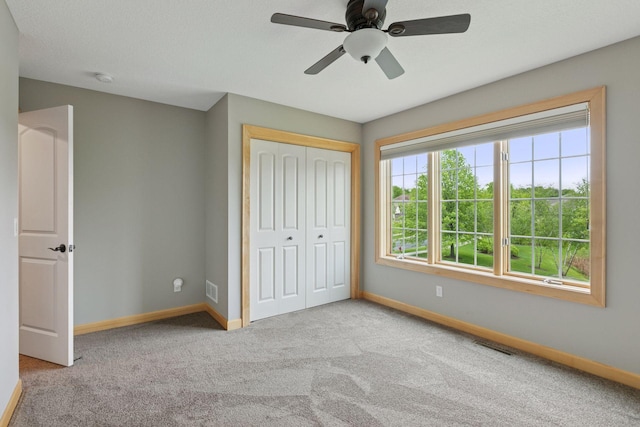 9885 Troy Ln N, Maple Grove, MN 55311 - unfurnished bedroom with baseboards, carpet, a closet, and ceiling fan