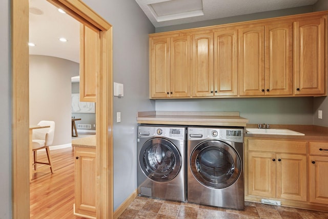 9885 Troy Ln N, Maple Grove, MN 55311 - laundry area featuring washer and dryer, cabinet space, arched walkways, and baseboards