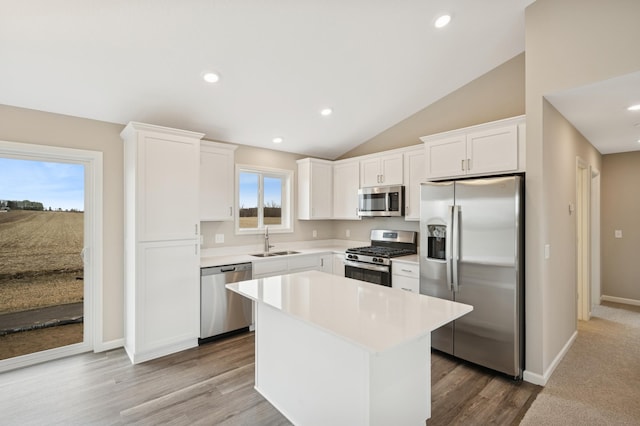 451 Mallard St NE, Hanover, MN 55341 - kitchen featuring appliances with stainless steel finishes, a sink, lofted ceiling, white cabinetry, and wood finished floors