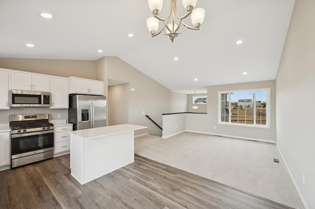 451 Mallard St NE, Hanover, MN 55341 - kitchen with appliances with stainless steel finishes, vaulted ceiling, light countertops, white cabinetry, and a center island