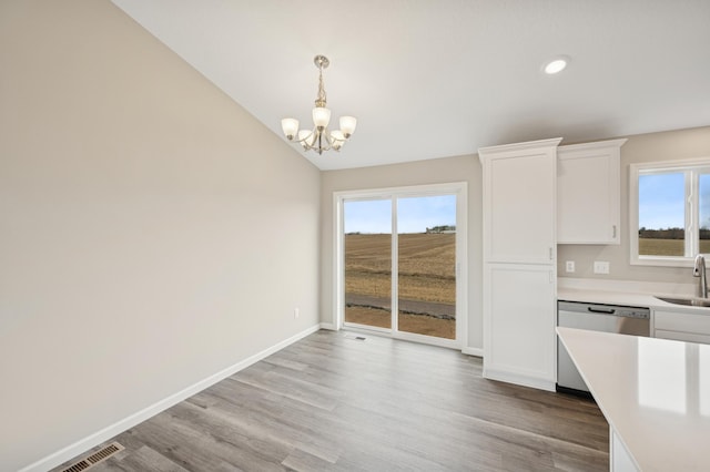 451 Mallard St NE, Hanover, MN 55341 - kitchen featuring a sink, light countertops, a chandelier, white cabinetry, and pendant lighting