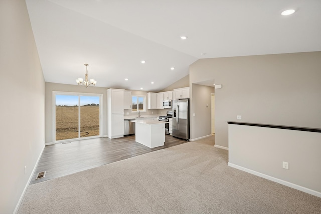 451 Mallard St NE, Hanover, MN 55341 - kitchen featuring stainless steel appliances, open floor plan, a chandelier, white cabinetry, and carpet flooring