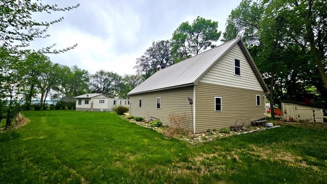33798 Shady Oak Dr, Foster Twp, MN 56225 - view of side of home with a lawn and metal roof