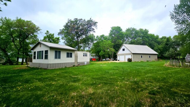 33798 Shady Oak Dr, Foster Twp, MN 56225 - view of grassy yard featuring a garage and an outdoor structure